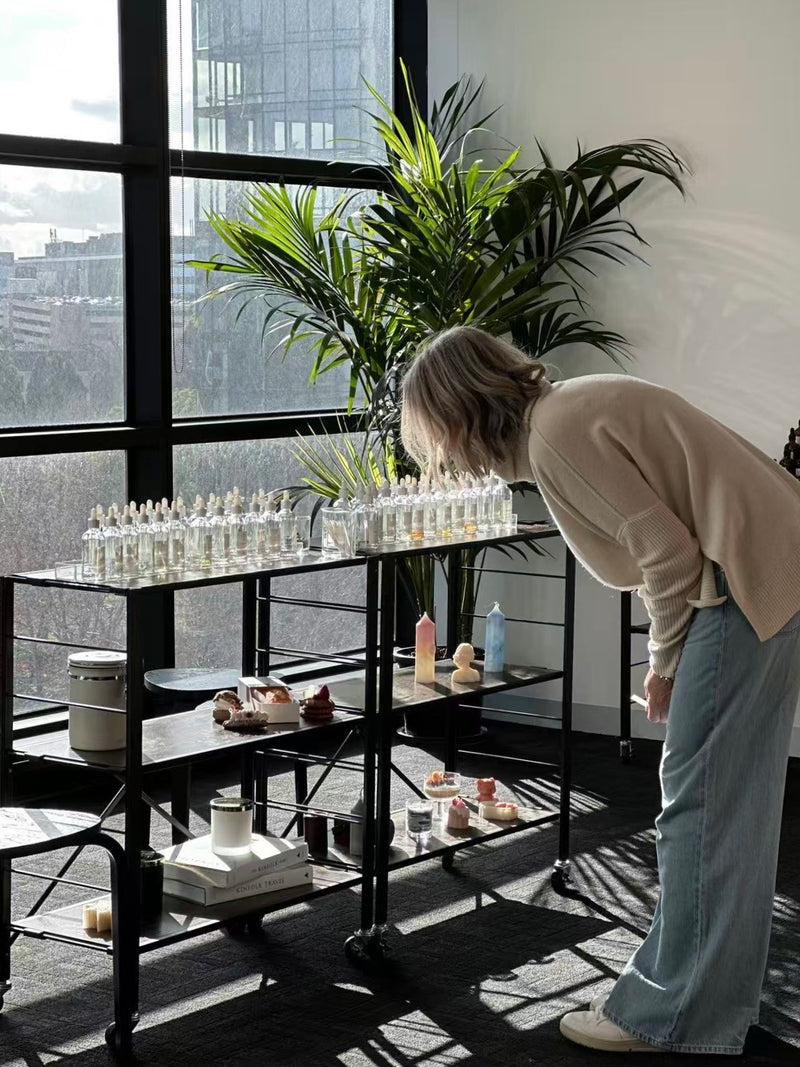 Person interacting with a display of small bottles 