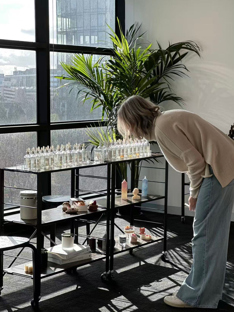 Person interacting with a display of small bottles 