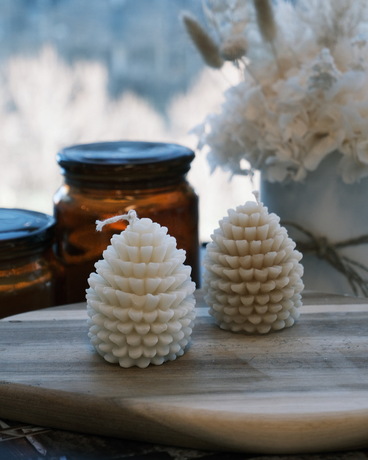 Two white textured candle cones