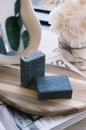 Two dark-colored soap bars