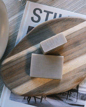 Two bars of soap on a wooden tray