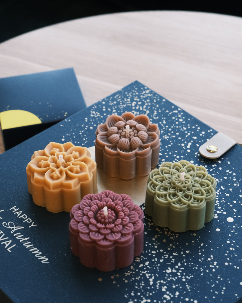 Four floral-patterned candles 