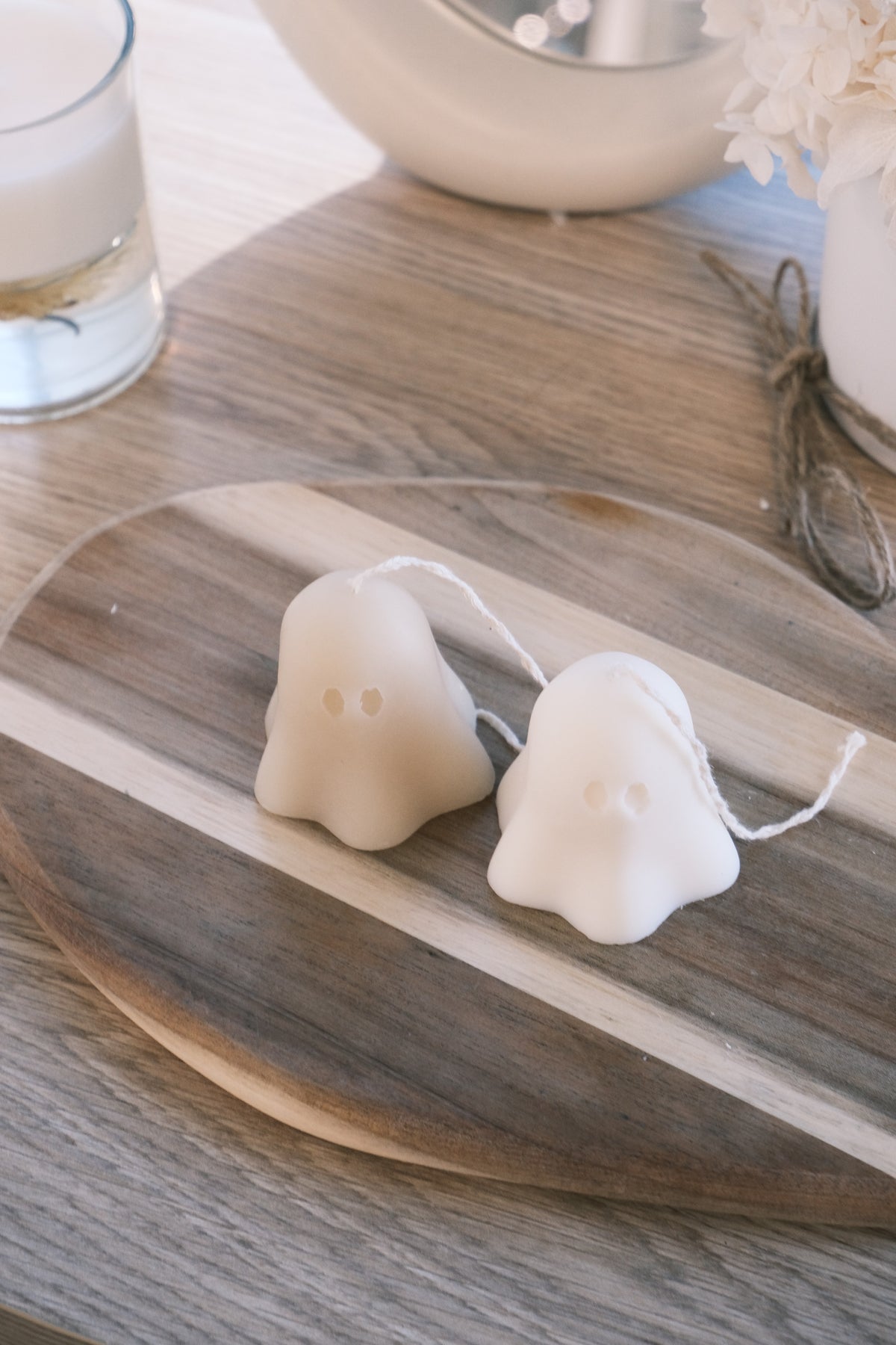 Two white ghost-shaped candles