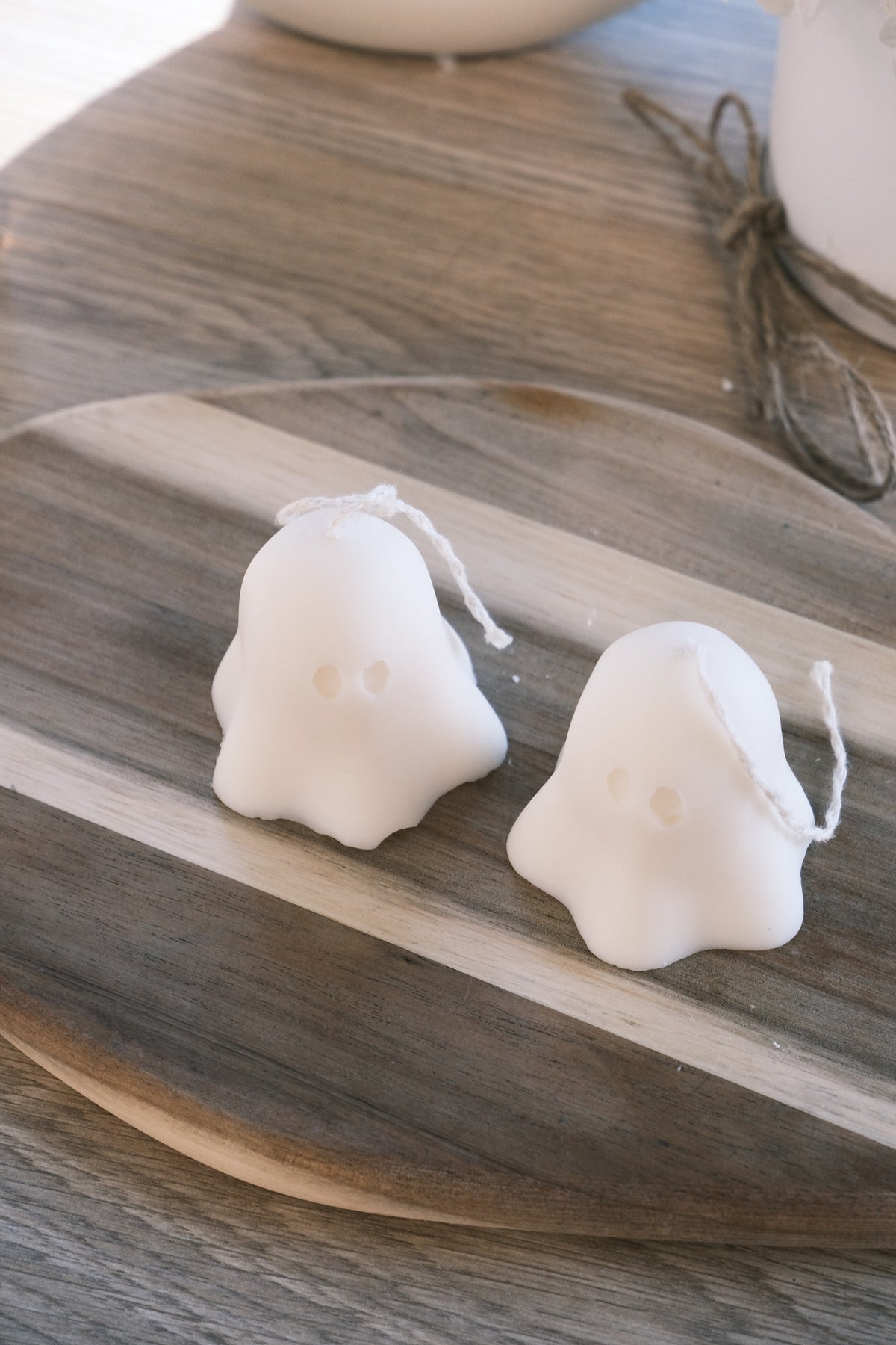 Two white ghost-shaped candles