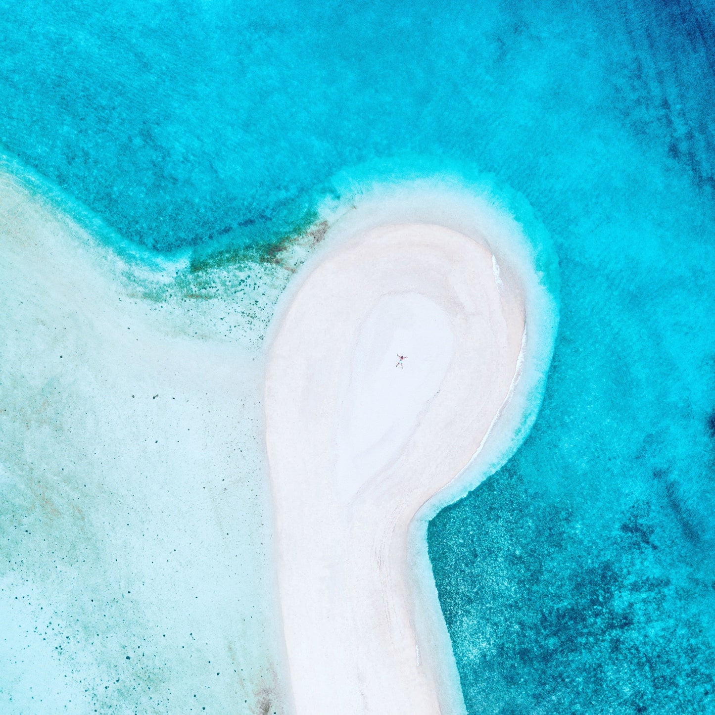 drone-image-of-person-on-white-sandy-beach