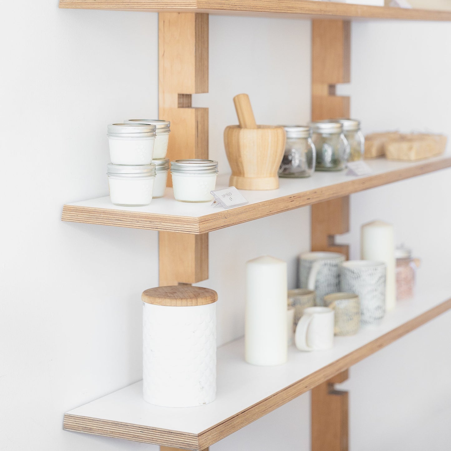 jars-candles-and-ceramics-on-wooden-shelves